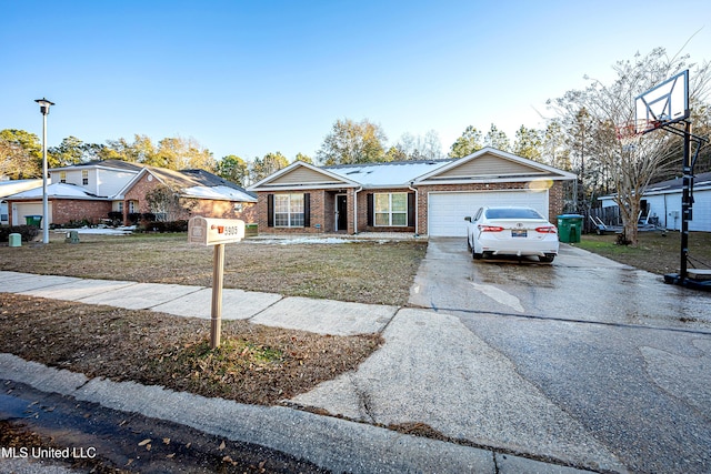 ranch-style home with a garage and a front yard