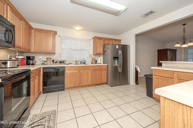 kitchen featuring pendant lighting, sink, backsplash, a chandelier, and black appliances