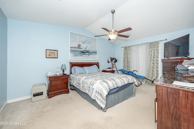 bedroom featuring a textured ceiling, vaulted ceiling, light colored carpet, and ceiling fan