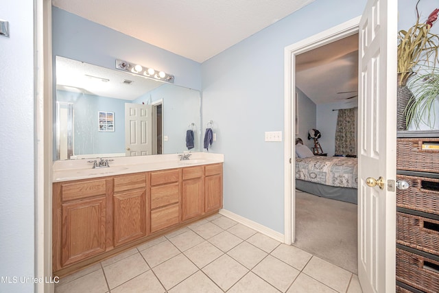 bathroom with vanity, tile patterned flooring, and a textured ceiling