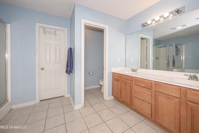 bathroom featuring walk in shower, toilet, a textured ceiling, vanity, and tile patterned flooring