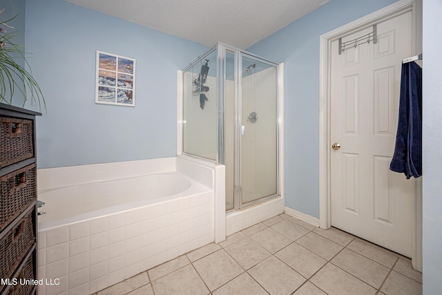 bathroom featuring a textured ceiling, tile patterned floors, and separate shower and tub