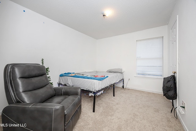 carpeted bedroom featuring a textured ceiling