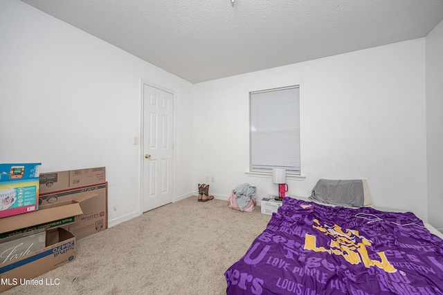 carpeted bedroom featuring a textured ceiling