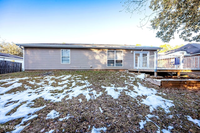 snow covered property featuring a deck