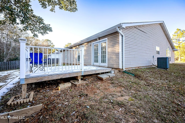 rear view of house featuring central AC unit and a deck