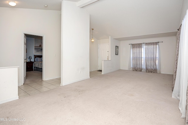 unfurnished room featuring lofted ceiling with beams and light colored carpet