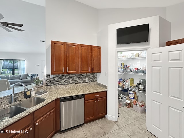 kitchen featuring a ceiling fan, light tile patterned flooring, open floor plan, a sink, and dishwasher