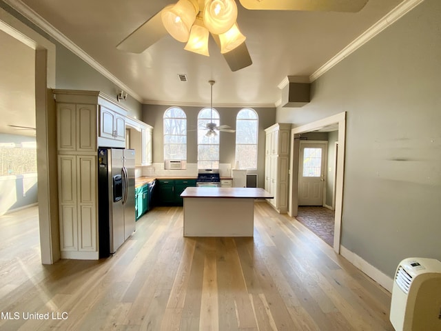 kitchen with crown molding, a center island, light hardwood / wood-style flooring, ceiling fan, and stainless steel appliances