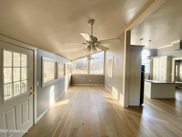 unfurnished sunroom featuring lofted ceiling and ceiling fan