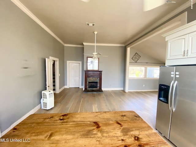 kitchen featuring stainless steel fridge with ice dispenser, white cabinets, ornamental molding, ceiling fan, and light hardwood / wood-style floors