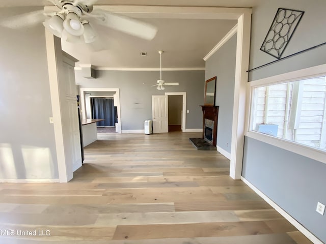 unfurnished living room with crown molding, light hardwood / wood-style floors, and ceiling fan