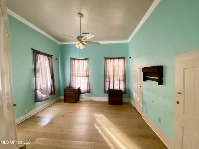 interior space with crown molding, ceiling fan, and light wood-type flooring
