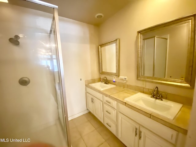 bathroom with vanity, tile patterned floors, and a shower with shower door