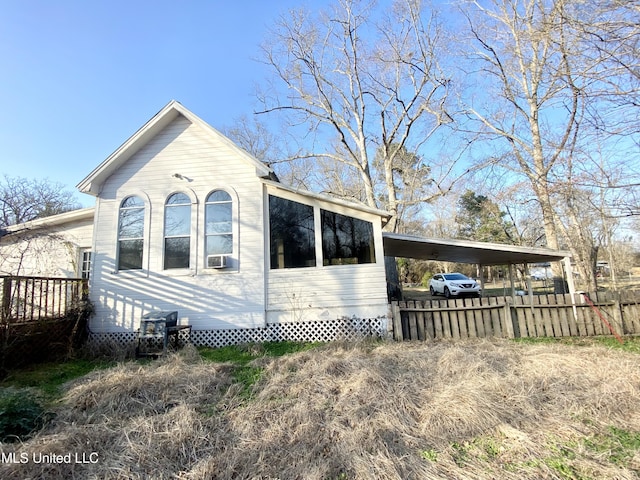 view of side of property featuring a carport