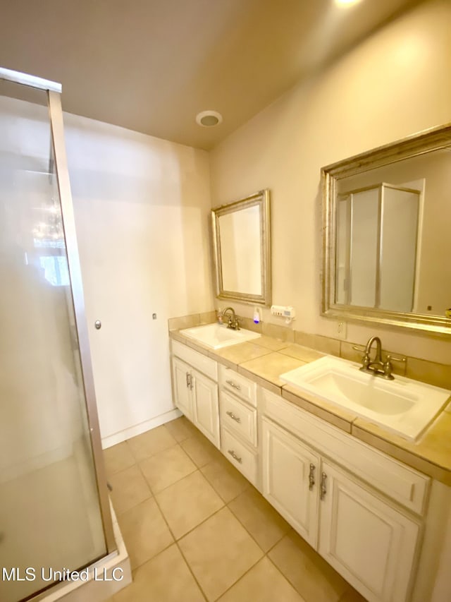 bathroom featuring vanity, tile patterned flooring, and walk in shower