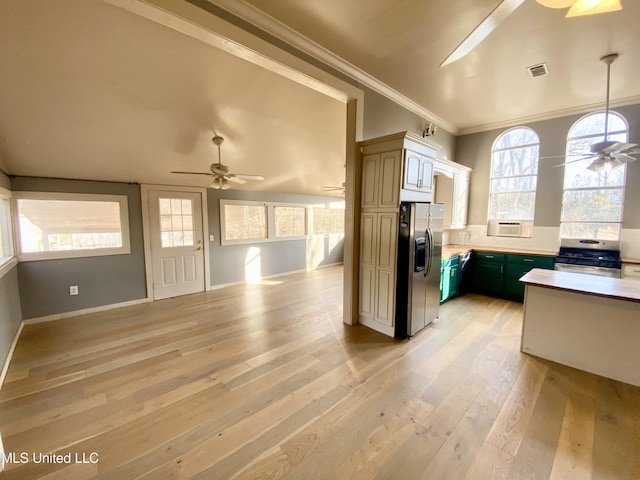 kitchen featuring appliances with stainless steel finishes, green cabinets, ceiling fan, light hardwood / wood-style floors, and crown molding