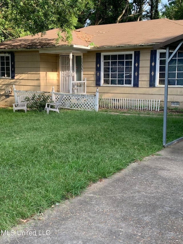 ranch-style house with a front lawn and covered porch