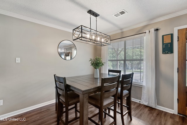 dining space with a chandelier, dark wood-type flooring, baseboards, crown molding, and a textured ceiling