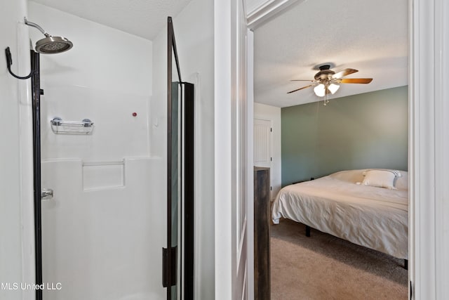 bedroom with a textured ceiling, carpet floors, and ceiling fan