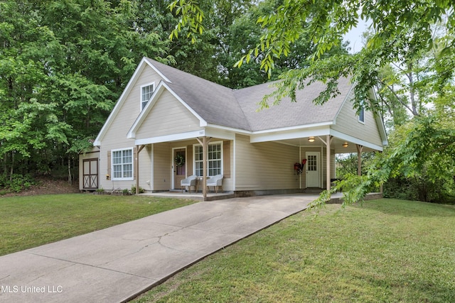 view of front of house featuring concrete driveway, a porch, an attached carport, and a front lawn
