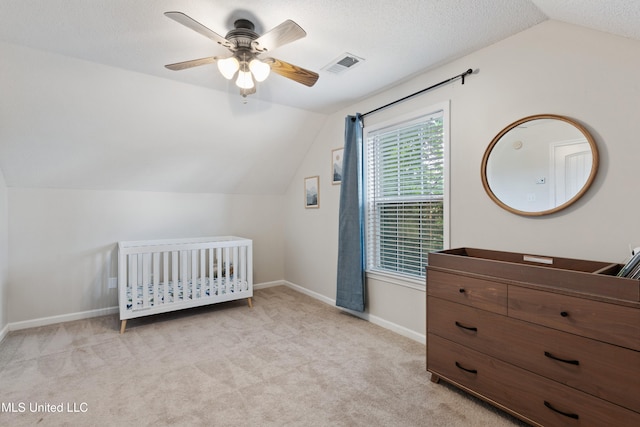 bedroom with lofted ceiling, carpet, baseboards, a ceiling fan, and a nursery area