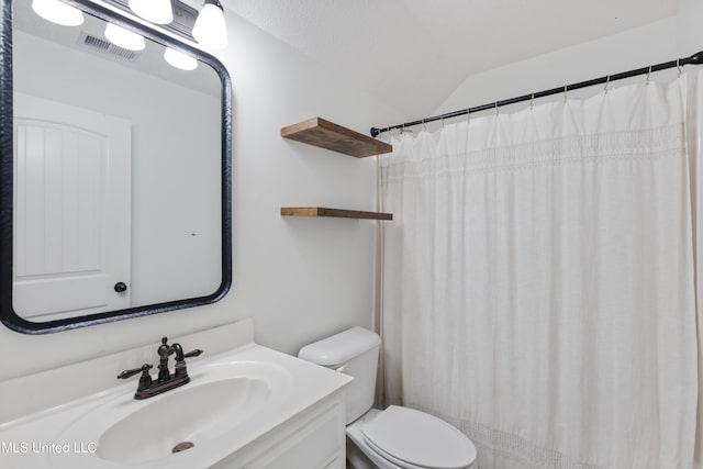 bathroom with toilet, vaulted ceiling, vanity, and a shower with curtain