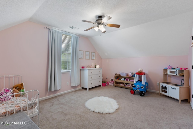 rec room featuring a ceiling fan, lofted ceiling, carpet floors, baseboards, and a textured ceiling