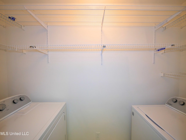 clothes washing area featuring laundry area and washing machine and clothes dryer