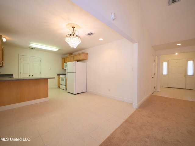 kitchen featuring recessed lighting, a peninsula, white appliances, visible vents, and baseboards