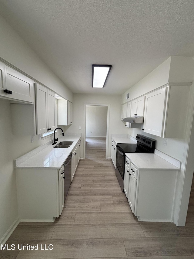 747 Cumberland Cv, Southaven, MS 38671 - kitchen with light countertops, a sink, appliances with stainless steel finishes, light wood-style flooring, and under cabinet range hood
