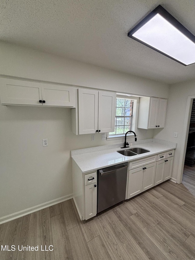 747 Cumberland Cv, Southaven, MS 38671 - kitchen featuring light countertops, a sink, dishwasher, white cabinets, and light wood-style floors