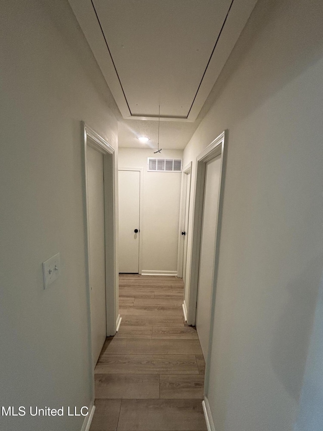 747 Cumberland Cv, Southaven, MS 38671 - hall with attic access, baseboards, visible vents, and light wood-style flooring