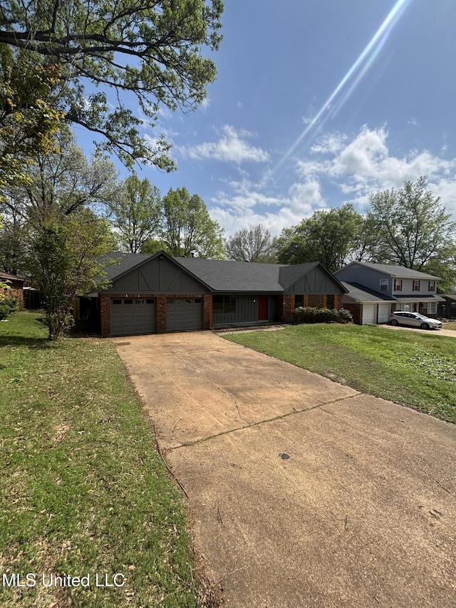 747 Cumberland Cv, Southaven, MS 38671 - view of front facade with a front yard, an attached garage, brick siding, and concrete driveway