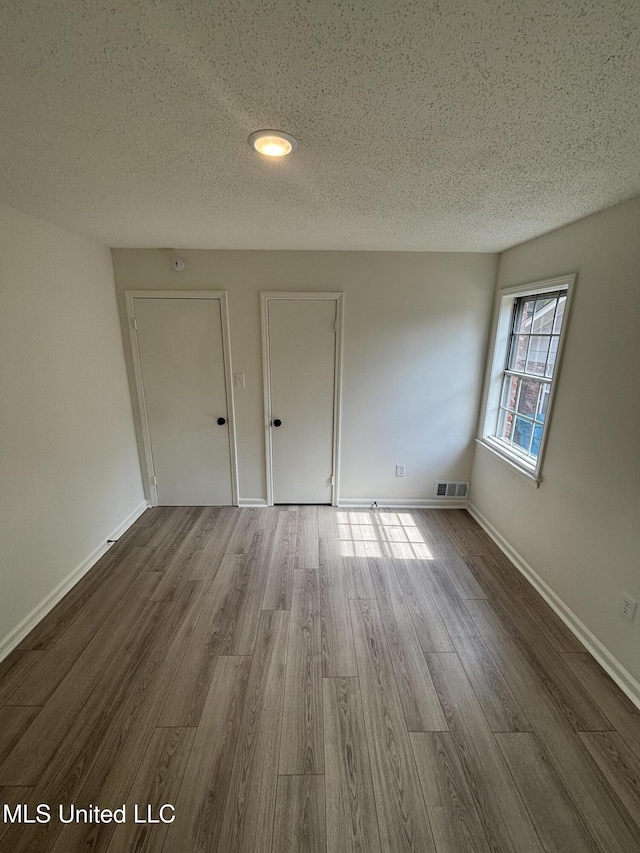 747 Cumberland Cv, Southaven, MS 38671 - spare room featuring baseboards, visible vents, wood finished floors, and a textured ceiling