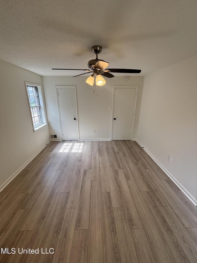 747 Cumberland Cv, Southaven, MS 38671 - interior space featuring baseboards, visible vents, a textured ceiling, and wood finished floors