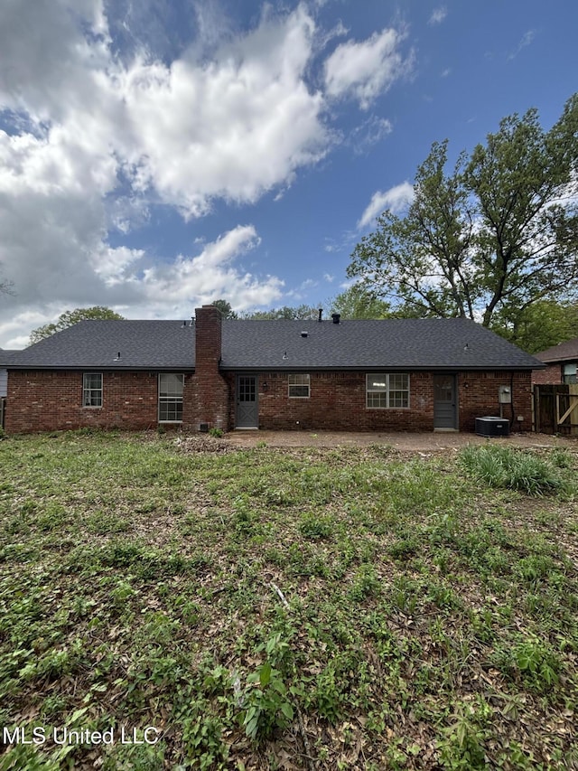 747 Cumberland Cv, Southaven, MS 38671 - rear view of property featuring fence, a patio, a chimney, brick siding, and a lawn