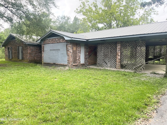 14920 Garrett St, Ocean Springs, MS 39565 - view of front of property with a front yard, brick siding, and metal roof