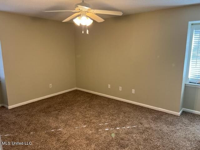 spare room with carpet floors and ceiling fan