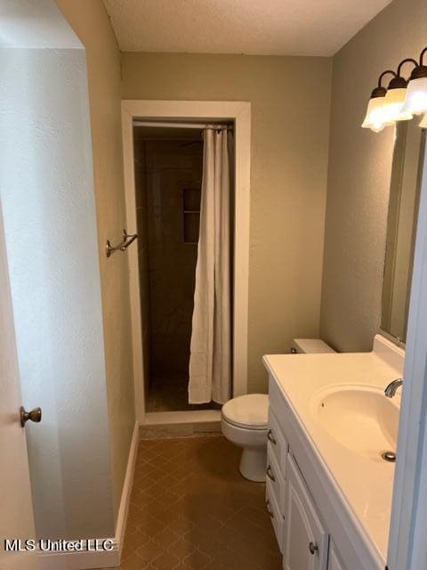 bathroom featuring curtained shower, a textured ceiling, toilet, tile patterned floors, and vanity