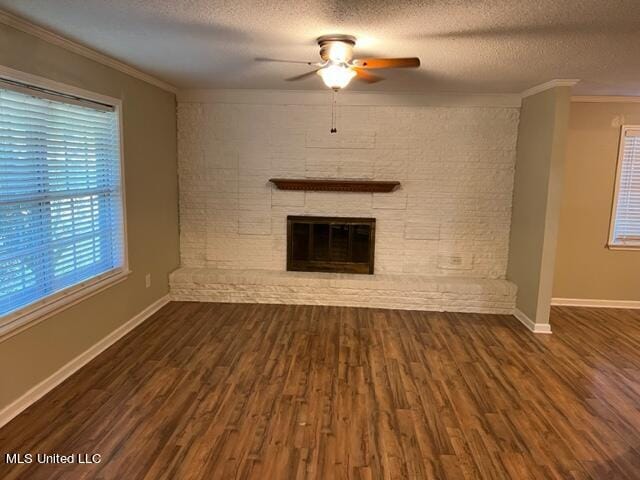 unfurnished living room featuring crown molding, a textured ceiling, dark hardwood / wood-style floors, and ceiling fan