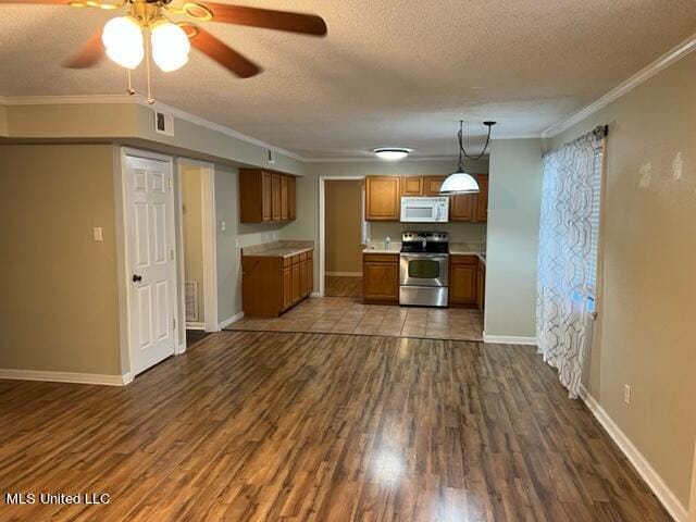 kitchen featuring dark wood-type flooring, stainless steel electric range, ornamental molding, and hanging light fixtures