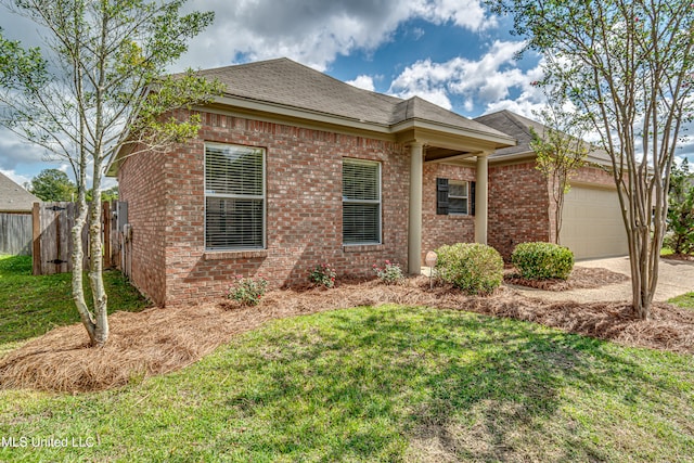 view of front of property with a front lawn and a garage