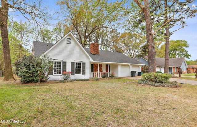 view of front of house featuring a chimney, a front yard, and a garage