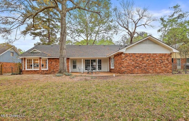 back of house featuring fence, a yard, a patio area, and brick siding