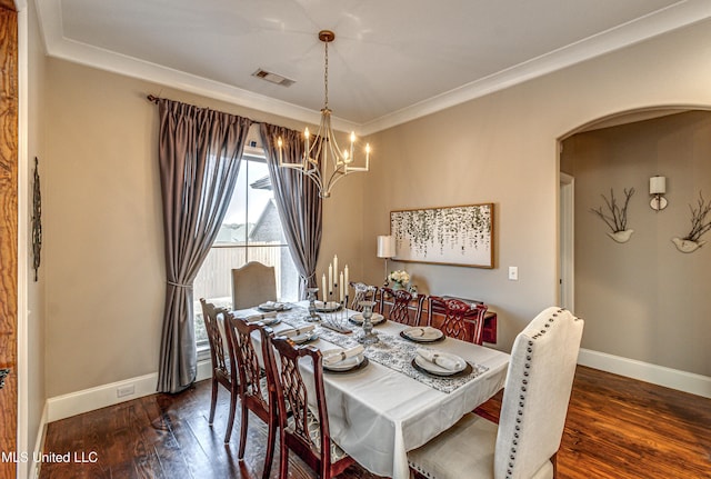 dining room featuring ornamental molding, a chandelier, and dark hardwood / wood-style flooring