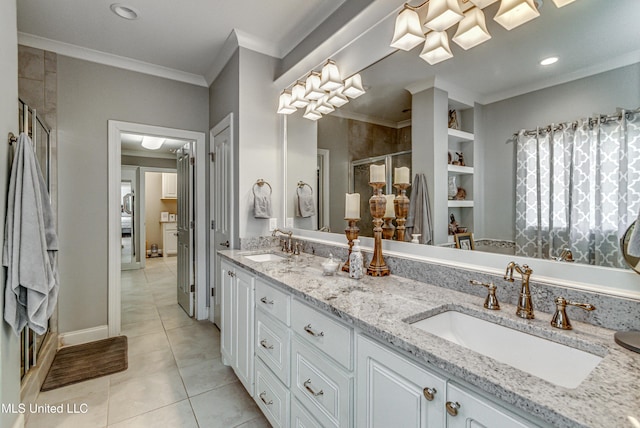 bathroom with tile patterned floors, vanity, ornamental molding, and walk in shower