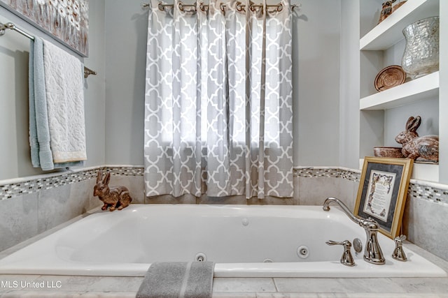 bathroom with a relaxing tiled tub