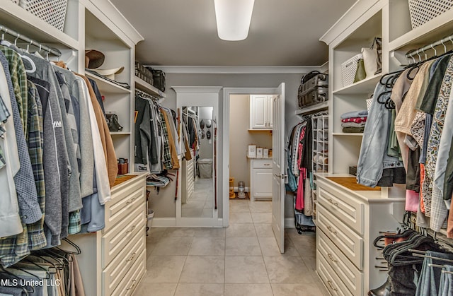 spacious closet with light tile patterned floors