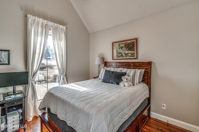 bedroom with lofted ceiling and dark hardwood / wood-style flooring